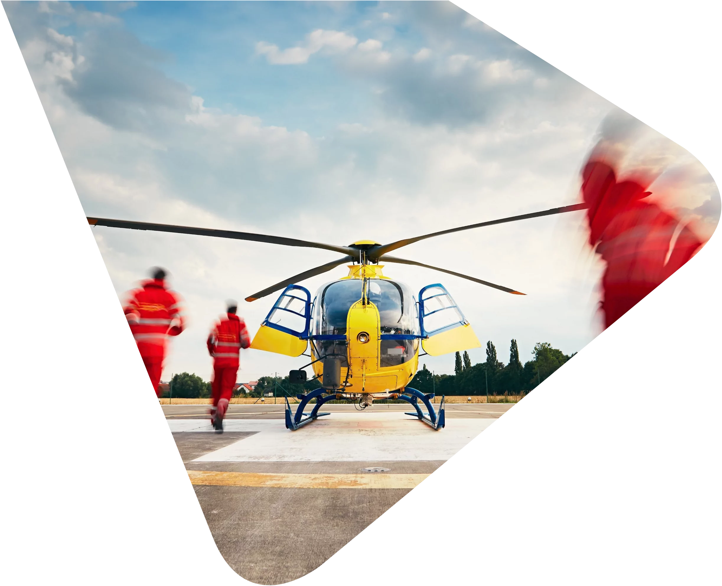 Air Ambulance doctors and medics wearing high vis running to a waiting yellow helicopter. Representing Woods Valldata's work with Air Ambulances and other local charities,
