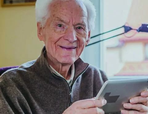 Positive Senior using Digital Tablet