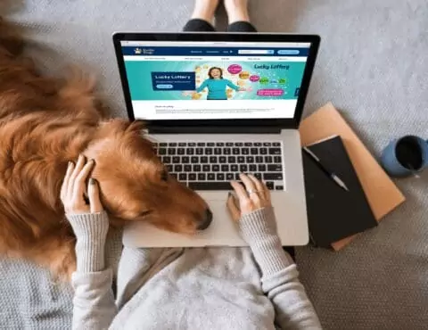 a dog resting his head on a laptop